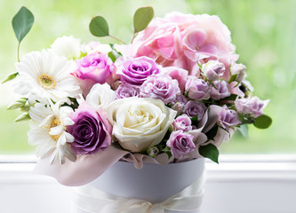 Beautiful flowers in a white round box
