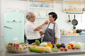 Asian Elderly couple cooking in the home kitchen.
