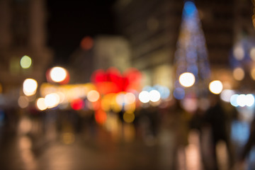 Christmas lights with blur bokeh. Night lights on street. Bokeh light abstract background..