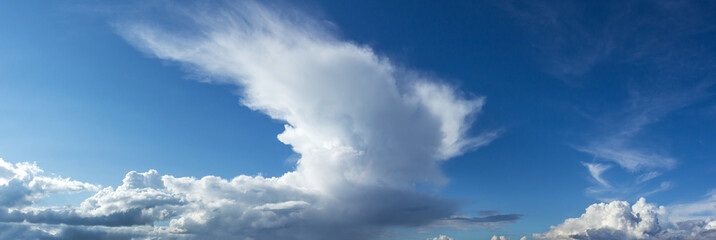 Fototapeta premium large rain clouds in broad daylight over a small town