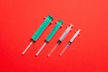 Top view of medical syringes on colorful background with copy space. Injection equipment concept
