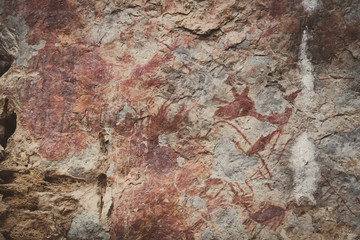 Ancient paintings painted by prehistoric people on the cliffs showing various stories of that era.