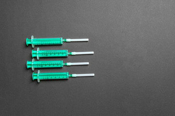Top view of different syringes for injection on colorful background. Medical equipment concept with copy space