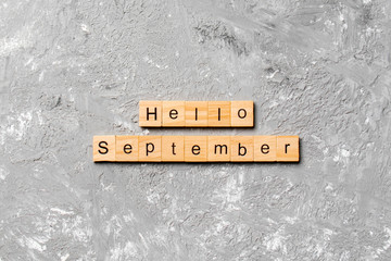 hello september word written on wood block. hello september text on table, concept