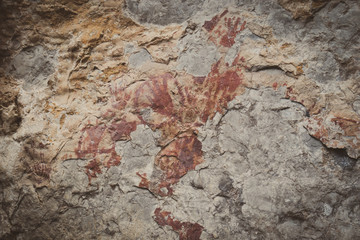 Ancient paintings painted by prehistoric people on the cliffs showing various stories of that era.