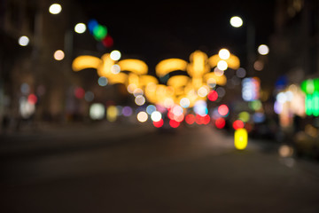 Christmas lights with blur bokeh. Night lights on street. Bokeh light abstract background..