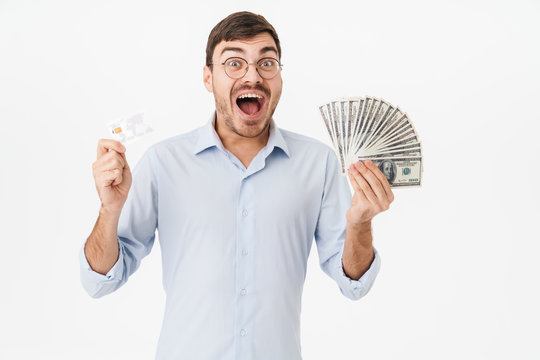 Photo of delighted man holding dollars and credit card