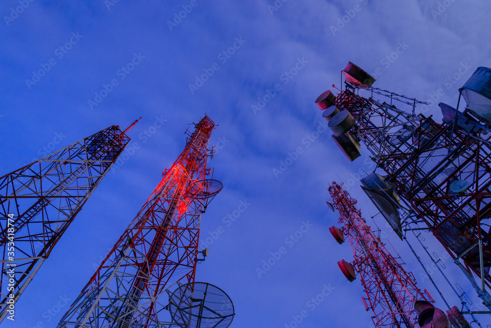 Wall mural radio antenna from low angle view operating at night