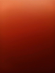 Dark red and orange gradient with mildly grunge shadow as blurred abstract background.