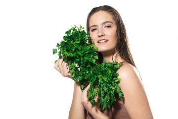 Green splash. Close up of beautiful young woman with parsley on white background. Concept of cosmetics, makeup, natural and eco treatment, skin care. Shiny and healthy skin, fashion, healthcare.