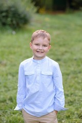 Portrait of a child boy outdoors on a warm sunny summer day.