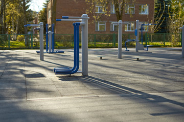 Outdoor fitness equipment in public park. Empty street exercise machines in a public place.