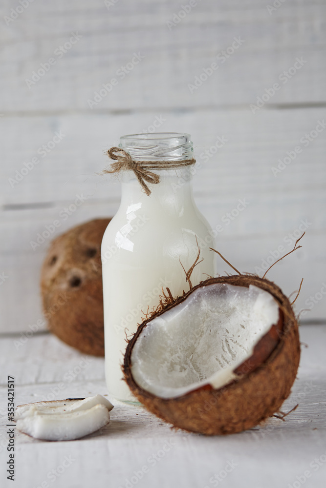 Wall mural Ripe coconuts with on light wooden table