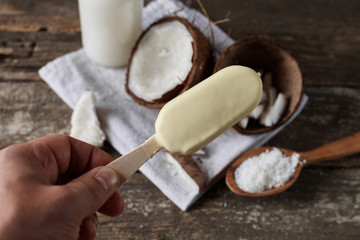 Ripe half cut coconut on a wooden background. Ripe half cut coconut on a wooden background. Coconut cream and oil.
