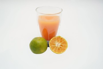 Close up a fresh orange cut in half and squeeze is juice.