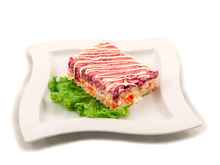 Serving of boiled vegetable salad garnished with mayonnaise and served on a lettuce leaf
