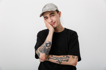 Portrait of perplexed confused man wearing black clothes looking at camera and propping up his head