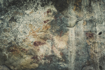 Ancient paintings painted by prehistoric people on the cliffs showing various stories of that era.