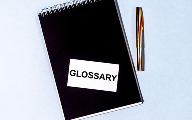 Word writing text Glossary on notebook withpen. Education concept. Vocabulary