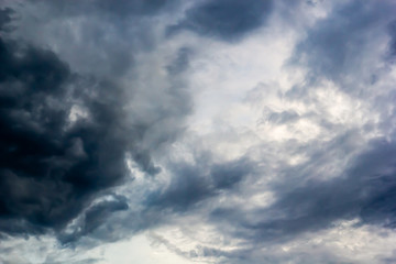 Naklejka na ściany i meble Dark clouds and blue dramatic sky with intense black cloud before raining, tropical cyclone in the rainy season