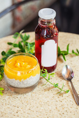 Chia in homemade soy milk with mango puree and mango chunk. Copy space, close-up. Pudding made with mangoes with extreme shallow depth of field with red juice