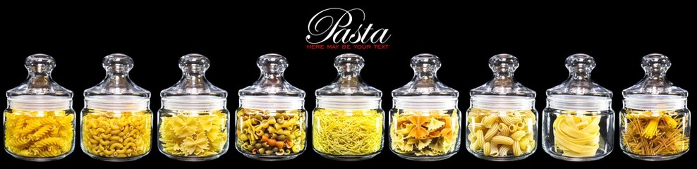 Different varieties of pasta in glass jars for storing food. Close-up. Black isolated background. Copy space for text. Concept for food advertising.