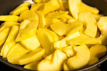 wok with apple slices cooked for pie
