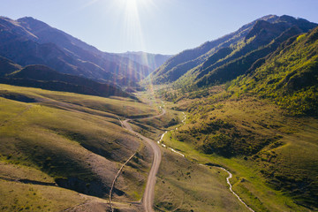 Mountain road aerial drone view, summer sunset
