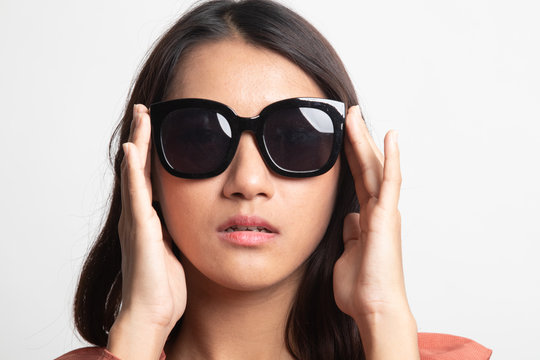 Portrait of a beautiful young asian girl in sunglasses .