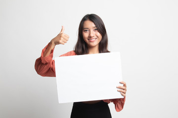 Fototapeta premium Young Asian woman show thumbs up with white blank sign .