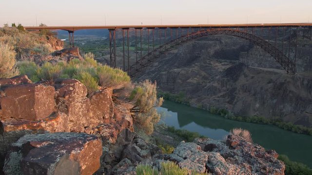 Perrine Bridge spanning over the Snake River Canyon in Twin Falls Idaho during sunrise.