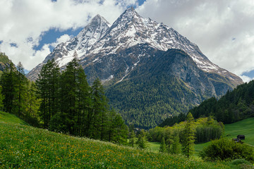 Fototapeta premium Peak of the mountains in the clouds on a background of blue sky.