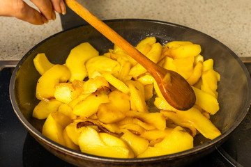 wok with apple slices cooked for pie