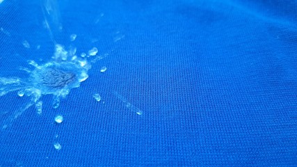 Rain drop on blue surface ,Water splash like a crown stock photos