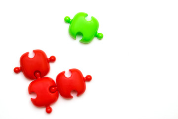 Red and green puzzles on a white background.Social distance concept   to prevent the spread of coronavirus COVID-19.Flat lay, copy space for text
