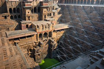 .Perspective stone stairs of the famous and deepest Chand Baori Step Well in Abhaneri, Rajasthan, India. Stepwells in which the water is reached by descending a set of steps to the water level