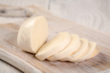 Fototapeta na wymiar Fresh cheeses on white wood. National cheeses prepared according to ancient recipes