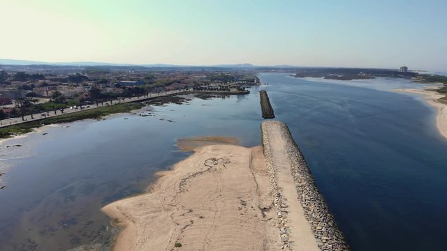 DRONE The two sides of Restinga de Ofir. One facing the ocean, the other the estuary of C&aacute;vado River. The jetty structure that protects the coastline from the currents and tides in Esposende, Portugal
