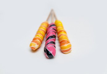 oblong colored lollipops on a light background