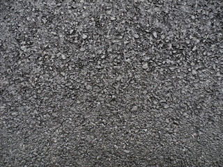 Black surface of fresh asphalt pavement. Rough bitumen texture. Background for design.   
