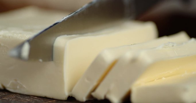 Butter cut into pieces with a knife.