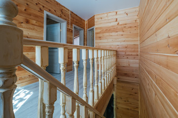 Wooden stairs and walls in simple eco house interior