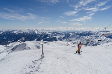 Naklejka na ściany i meble Snowboarders are about to slide down the slope of the Gudauri ski resort