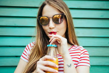 Orange juice drinking woman.A beautiful young girl drinking orange juice