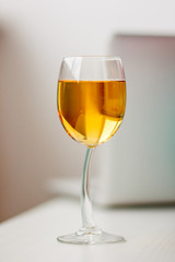 a glass of apple juice, a golden drink in а high standing glass
