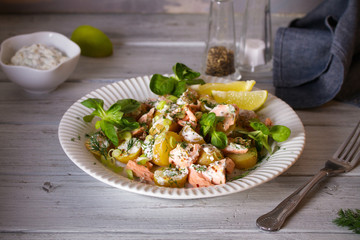 Poached Salmon salad with baby potatoes  and yogurt dressing. Horizontal image