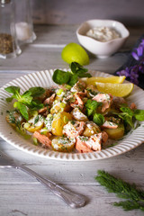 Poached Salmon salad with baby potatoes  and yogurt dressing. vertical image