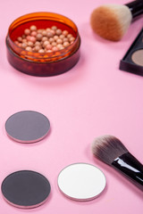 Unfolded open cosmetics on a pink background