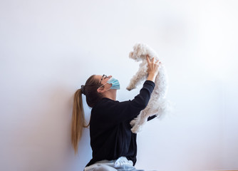 A Girl playing with her dog at home.