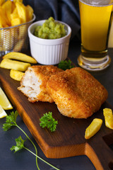 Traditional fish and chips with mushy peas and glass of beer